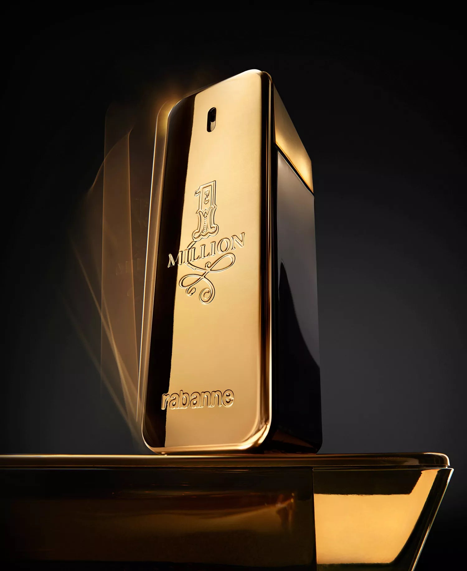 Gold perfume bottle with '1 Million' branding on a dark background