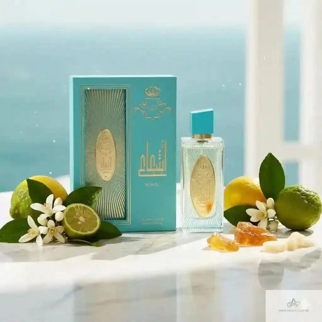 Perfume bottle with packaging and citrus fruits on a light surface