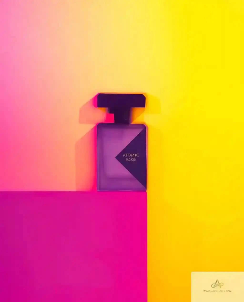 Perfume bottle labeled 'Atomic Rose' on a gradient pink to yellow background