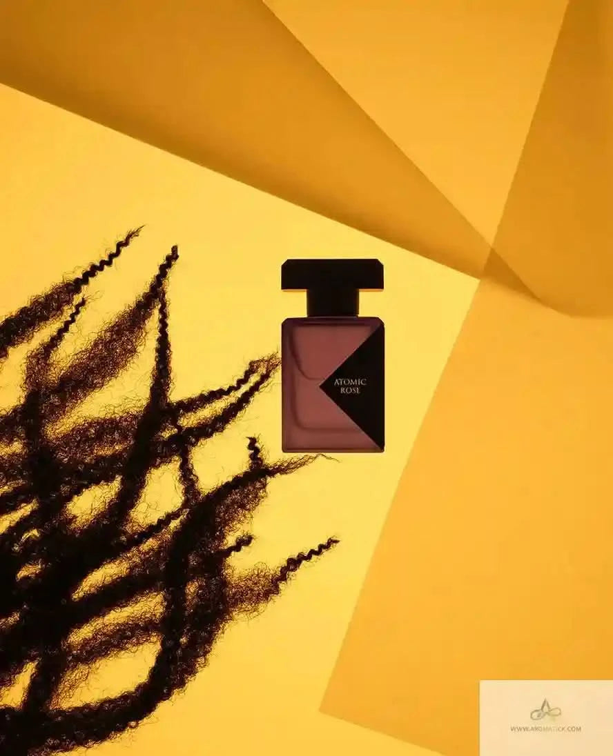 Perfume bottle with black cap on a yellow background