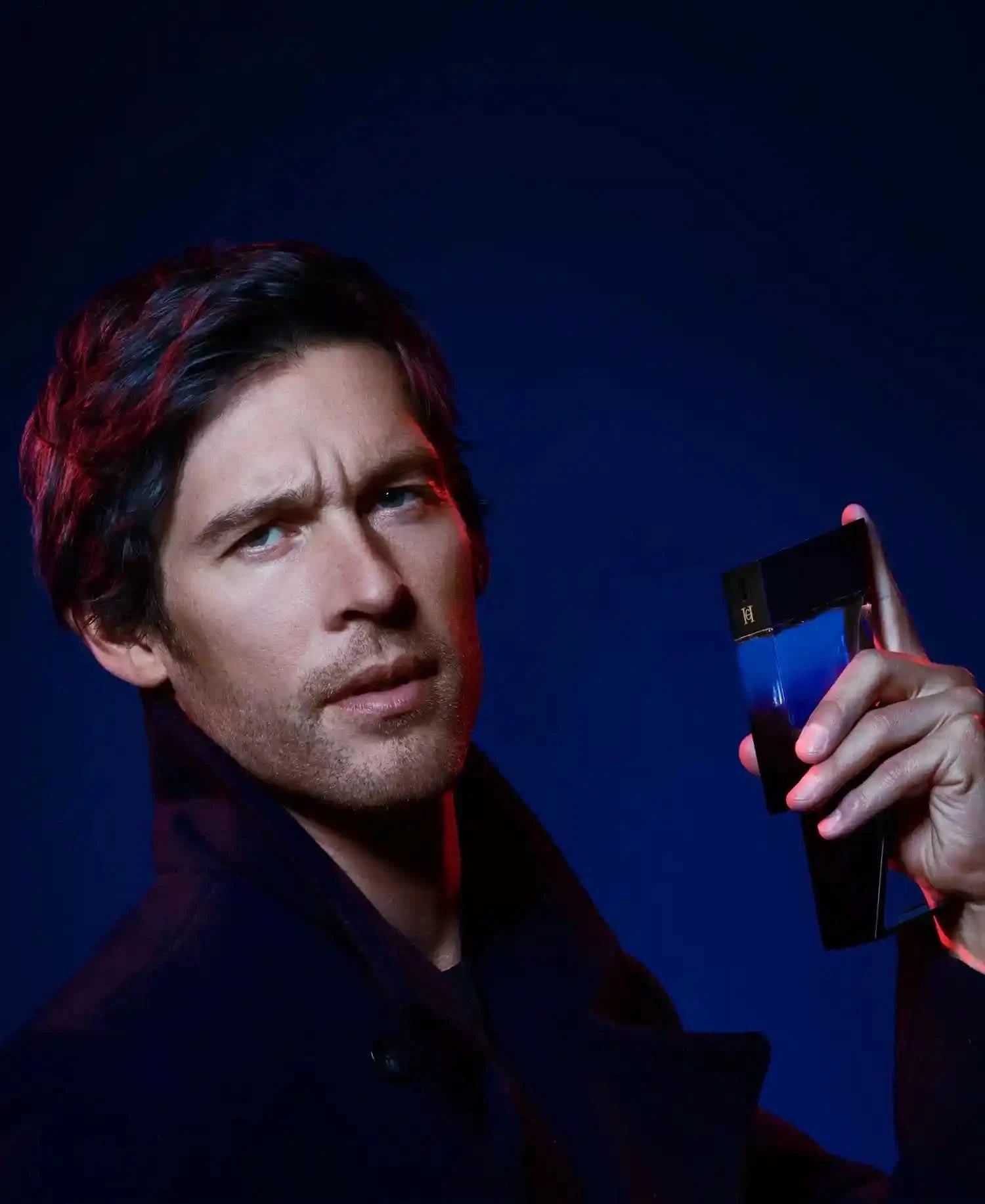 Man holding a smartphone with a dark blue background