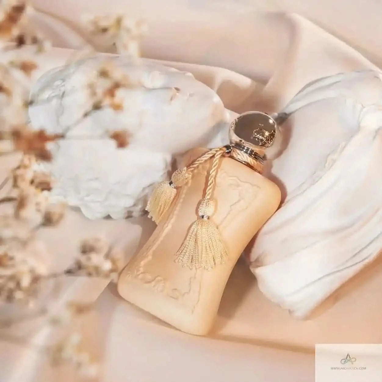 Decorative bottle with tassel on a soft fabric background