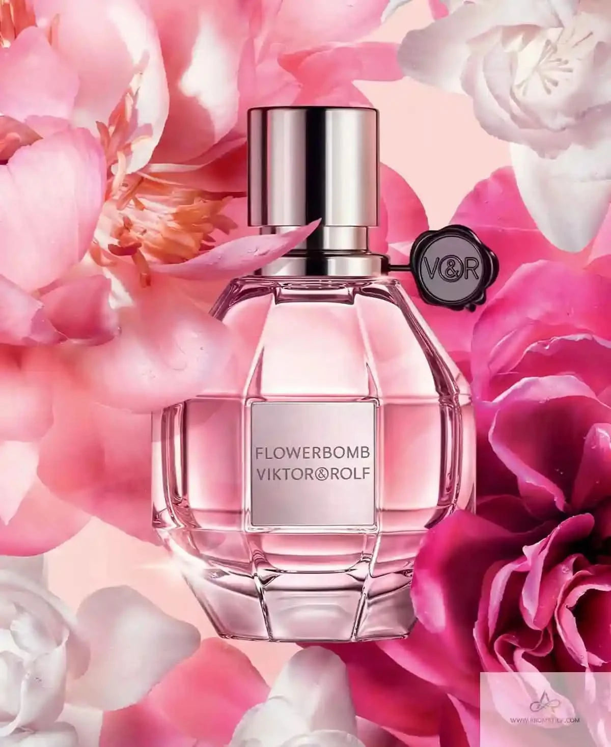 Viktor & Rolf Flowerbomb perfume bottle with pink flowers in the background