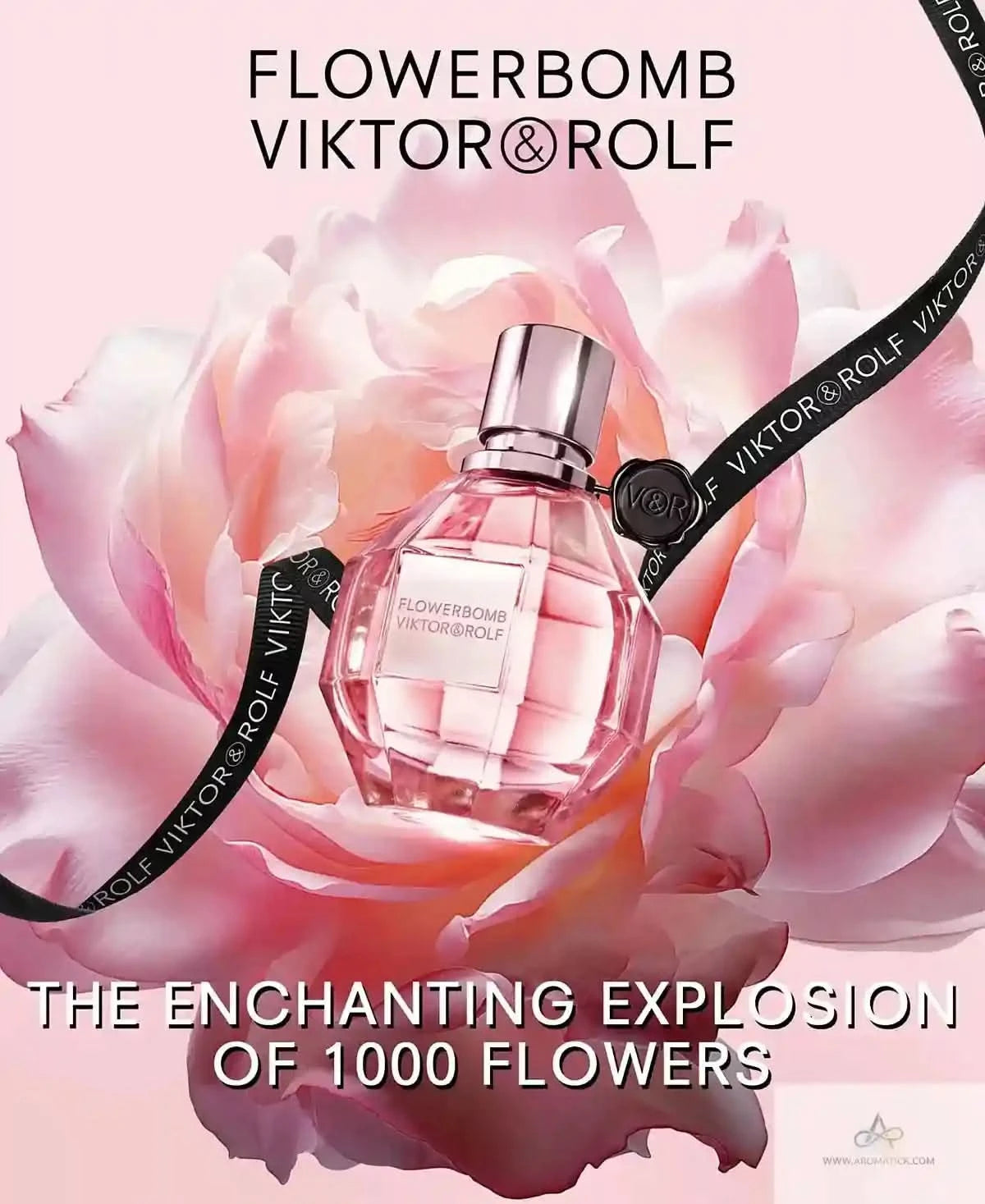 Viktor & Rolf Flowerbomb perfume bottle surrounded by pink flowers on a light pink background.