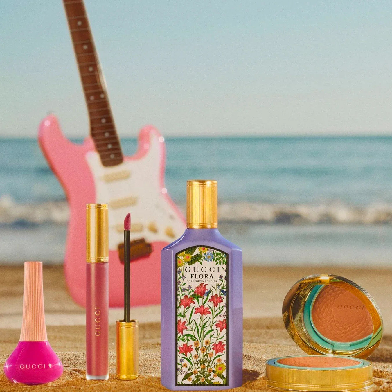 Gucci beauty products on a beach with a guitar in the background