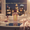 Perfume bottle on a dresser with city lights in the background
