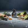 Aromatherapy diffuser with herbs and limes on a gray surface