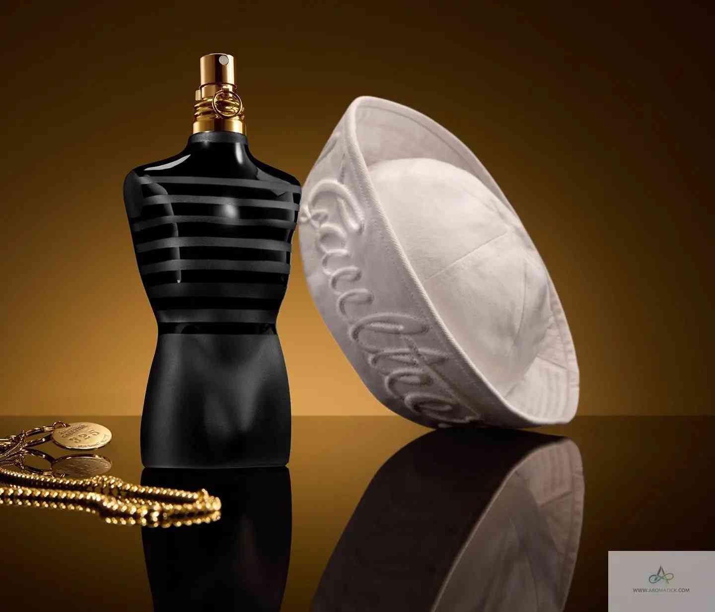 Le Male Le Parfum - Aromatick cologne bottle displayed with white sailor hat and gold chain, emphasizing its nautical-inspired design.