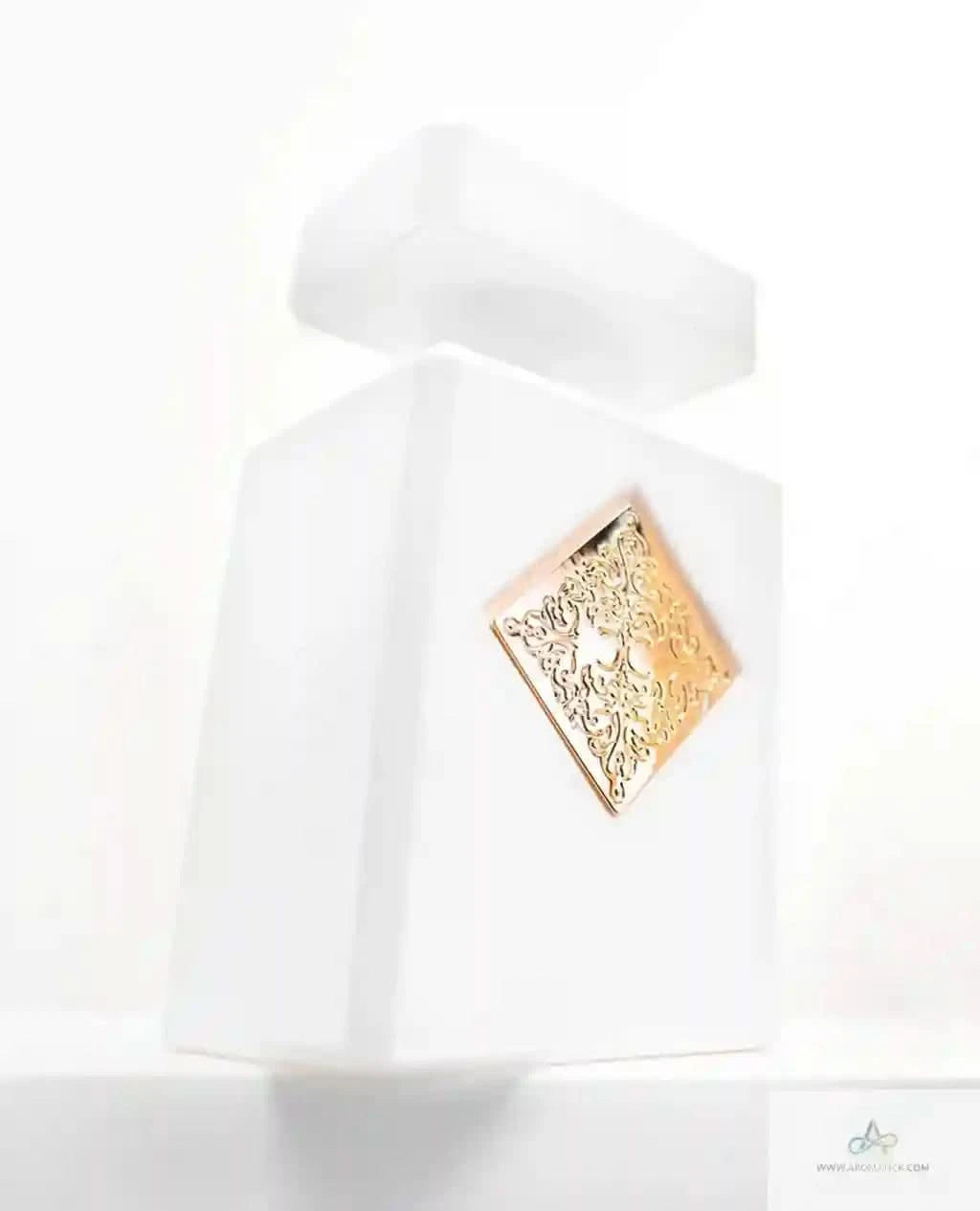 White dress with a gold brooch on a white background