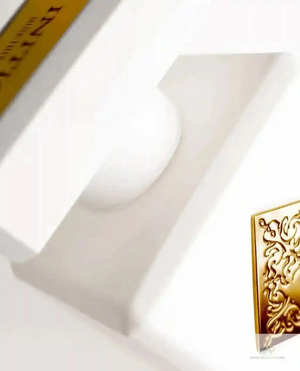 Close-up of a white product with gold accents on a white background