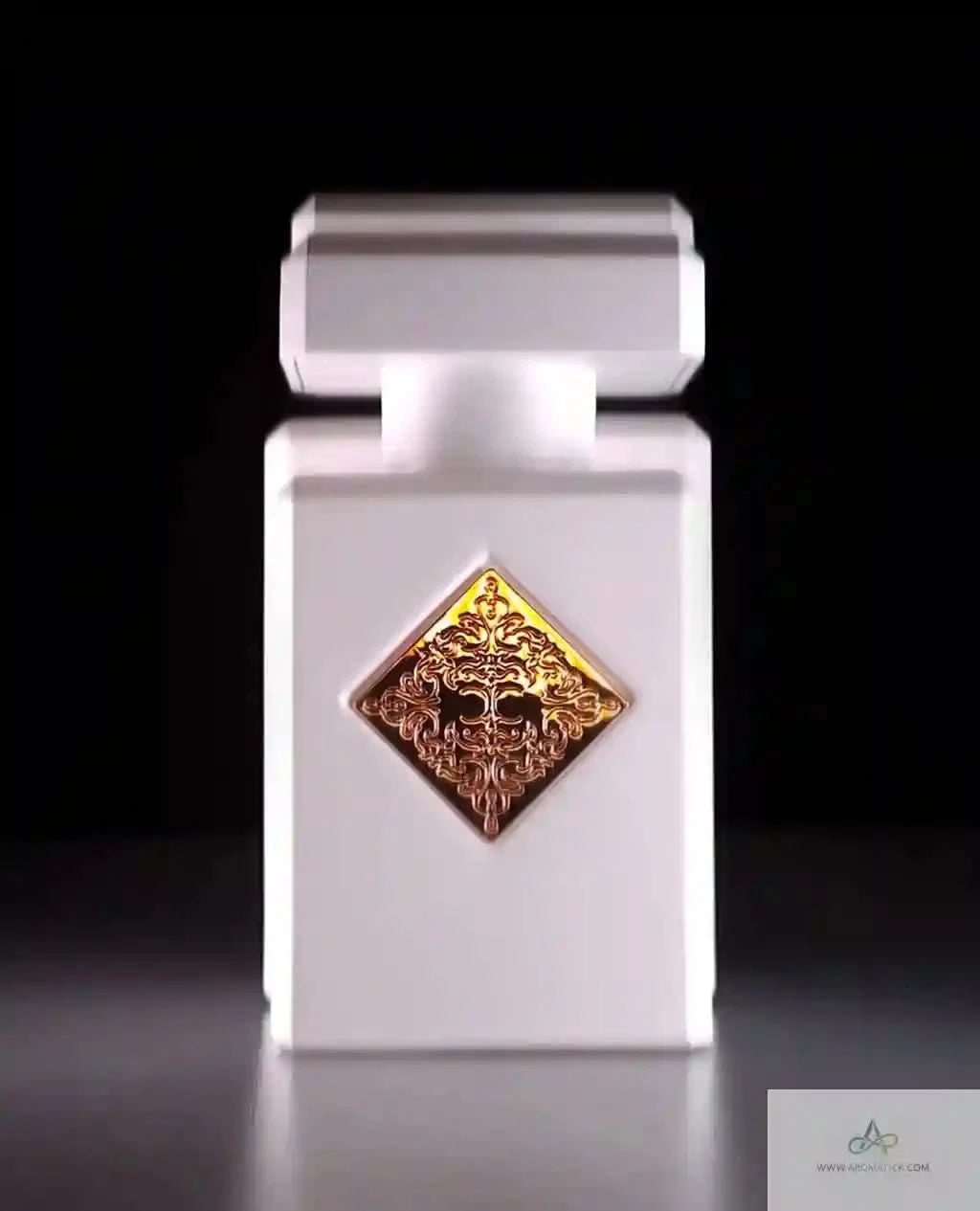 White perfume bottle with a gold and bronze emblem on a black background