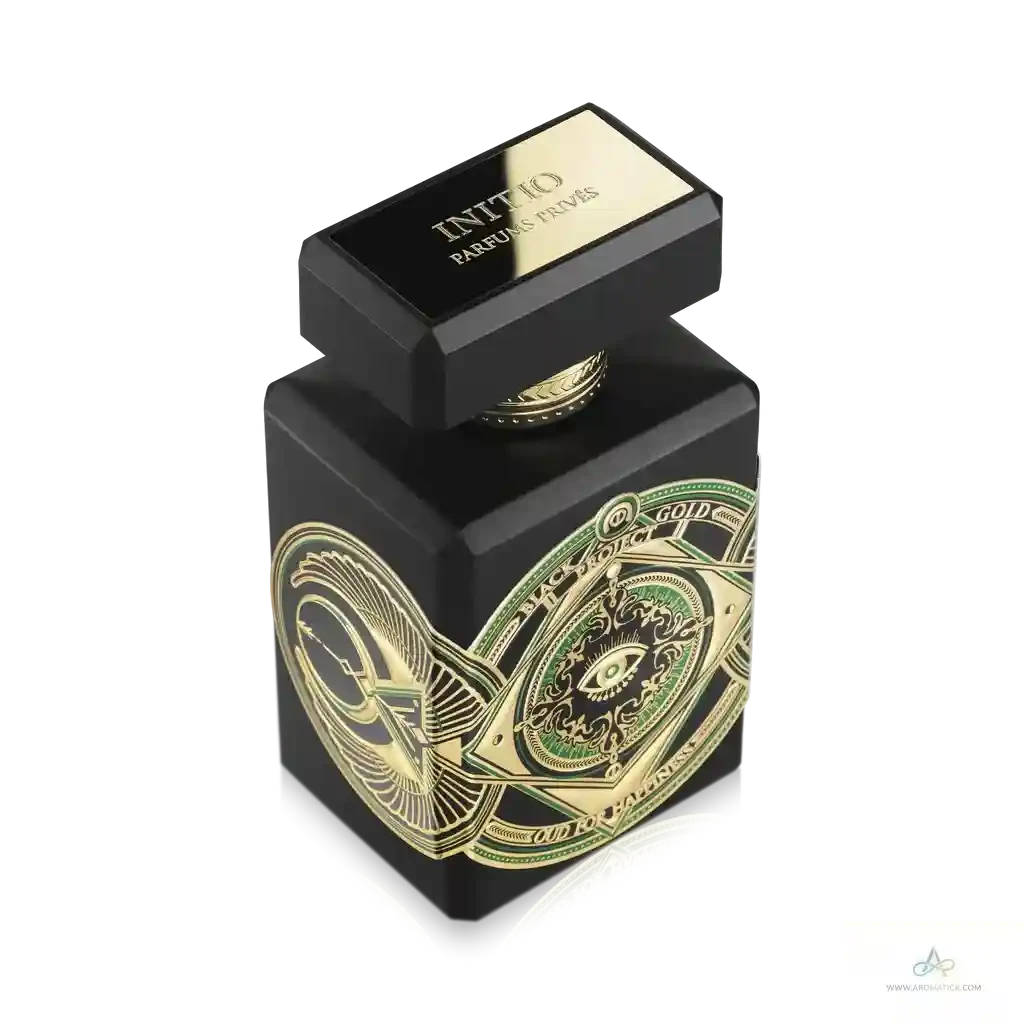 Black and gold perfume bottle with intricate design on a white background