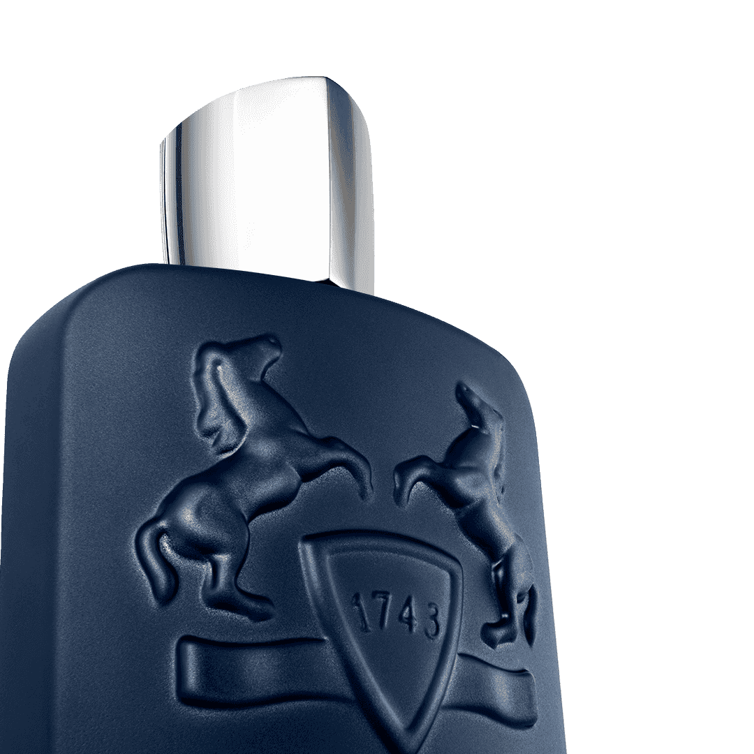 Close-up of PDM Layton Royal Essence EDP bottle showing embossed horse emblem and sleek silver cap for luxury fragrance appeal.