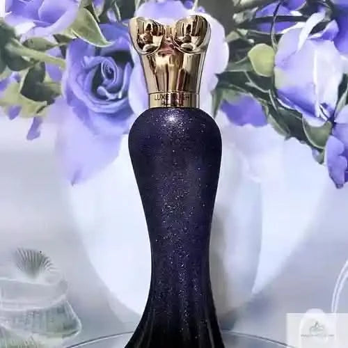 Black glittery perfume bottle with gold cap on a floral background
