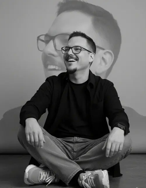 Rodney Gallagher, CEO & Founder of Aromatick, sitting cross-legged with a projected image of himself behind him