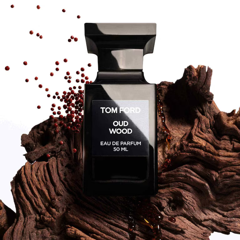 Tom Ford Oud Wood EDP 50 ml unisex perfume on textured wood with spice accents, highlighting its rich woody scent profile.