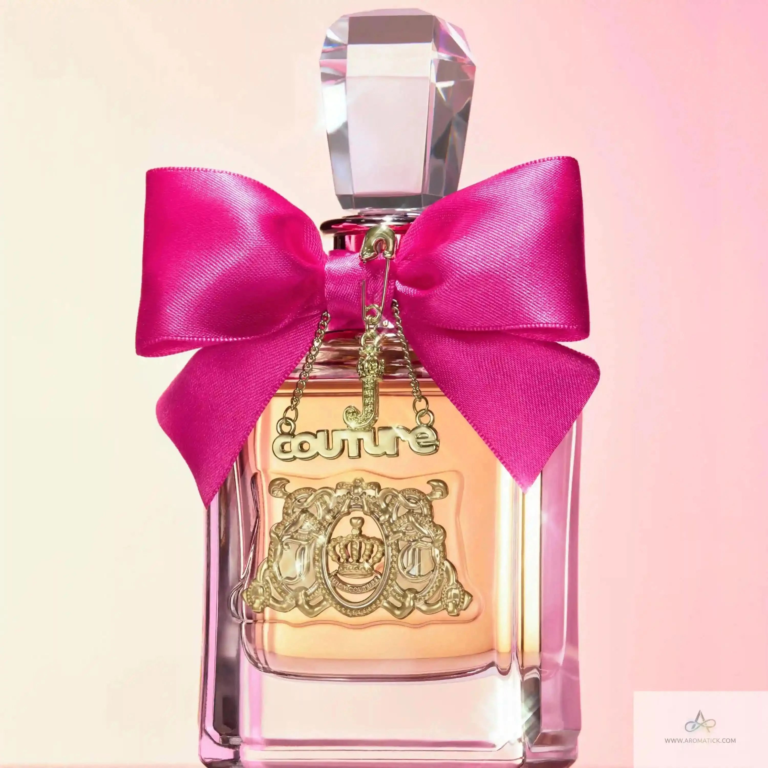 Close-up of Viva La Juicy - Aromatick perfume bottle with pink bow and gold crest, a top pick in women's perfumes for sweet and iconic scents.