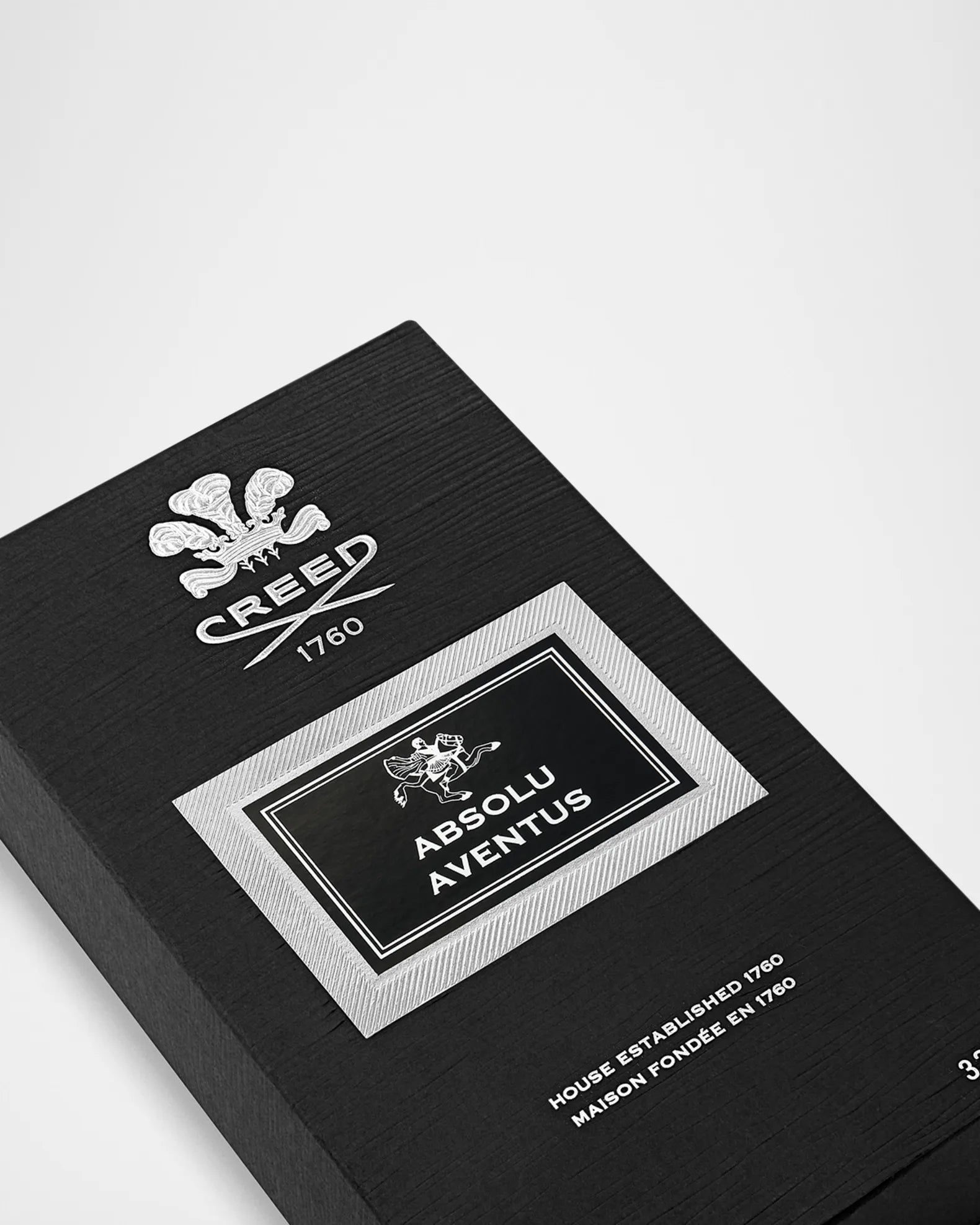 Black box with Creed Absolu Aventus branding on a white background