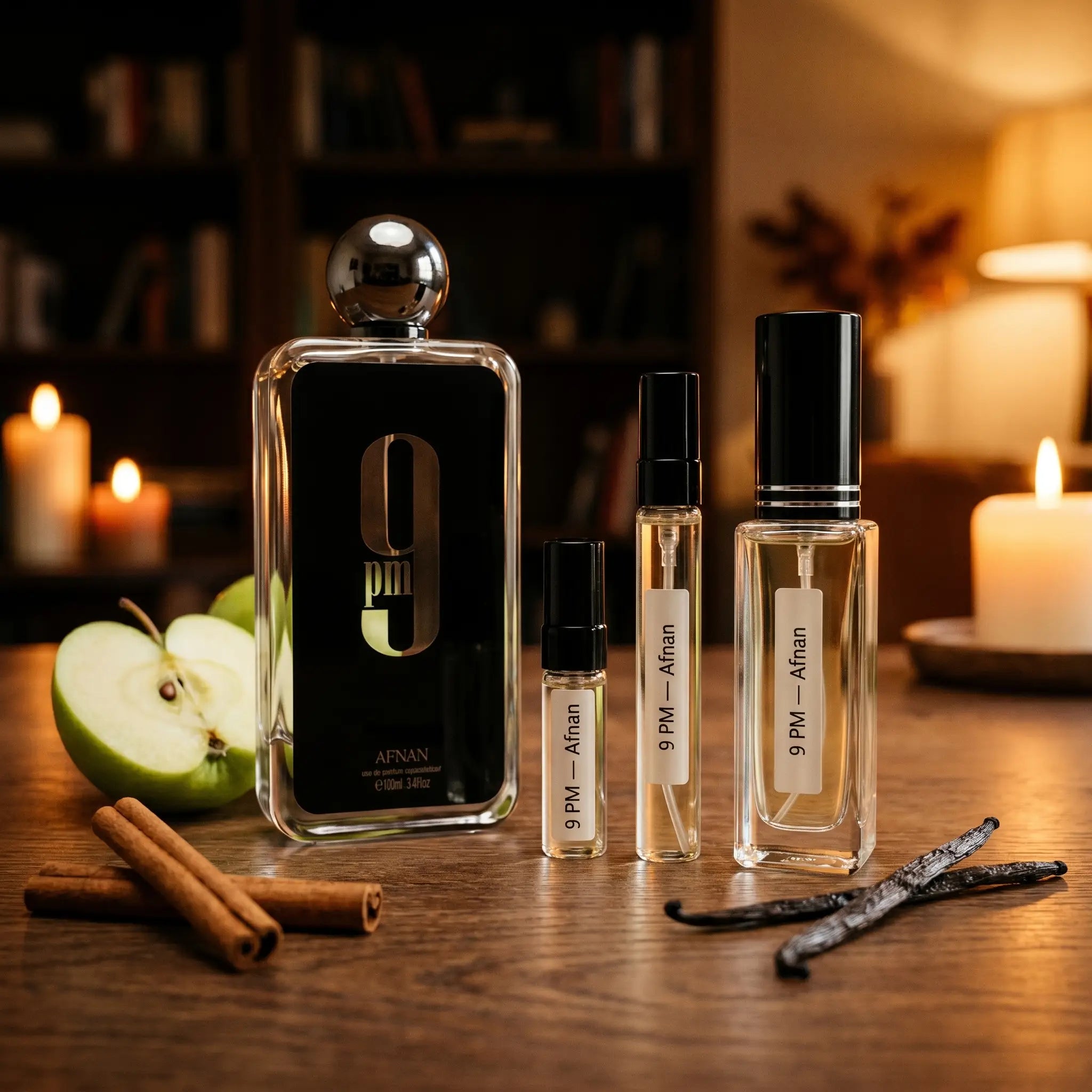 Afnan 9PM bottle and decants on wood table with green apple cinnamon and vanilla pods in candlelit study

