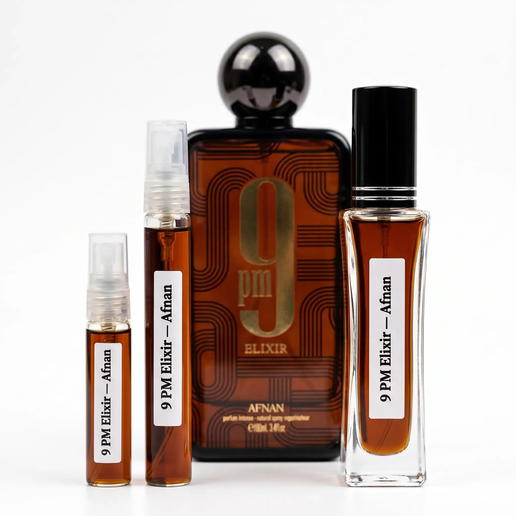 Afnan 9PM Elixir decants next to full cognac-brown bottle with gunmetal ball cap on white background