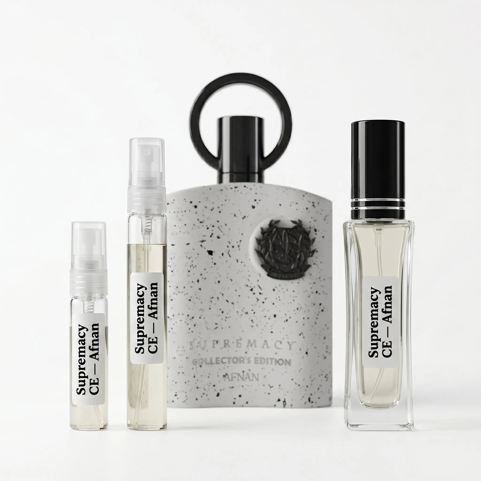 Afnan Supremacy Collector's Edition decants 5ml 10ml and 30ml next to full concrete-textured bottle