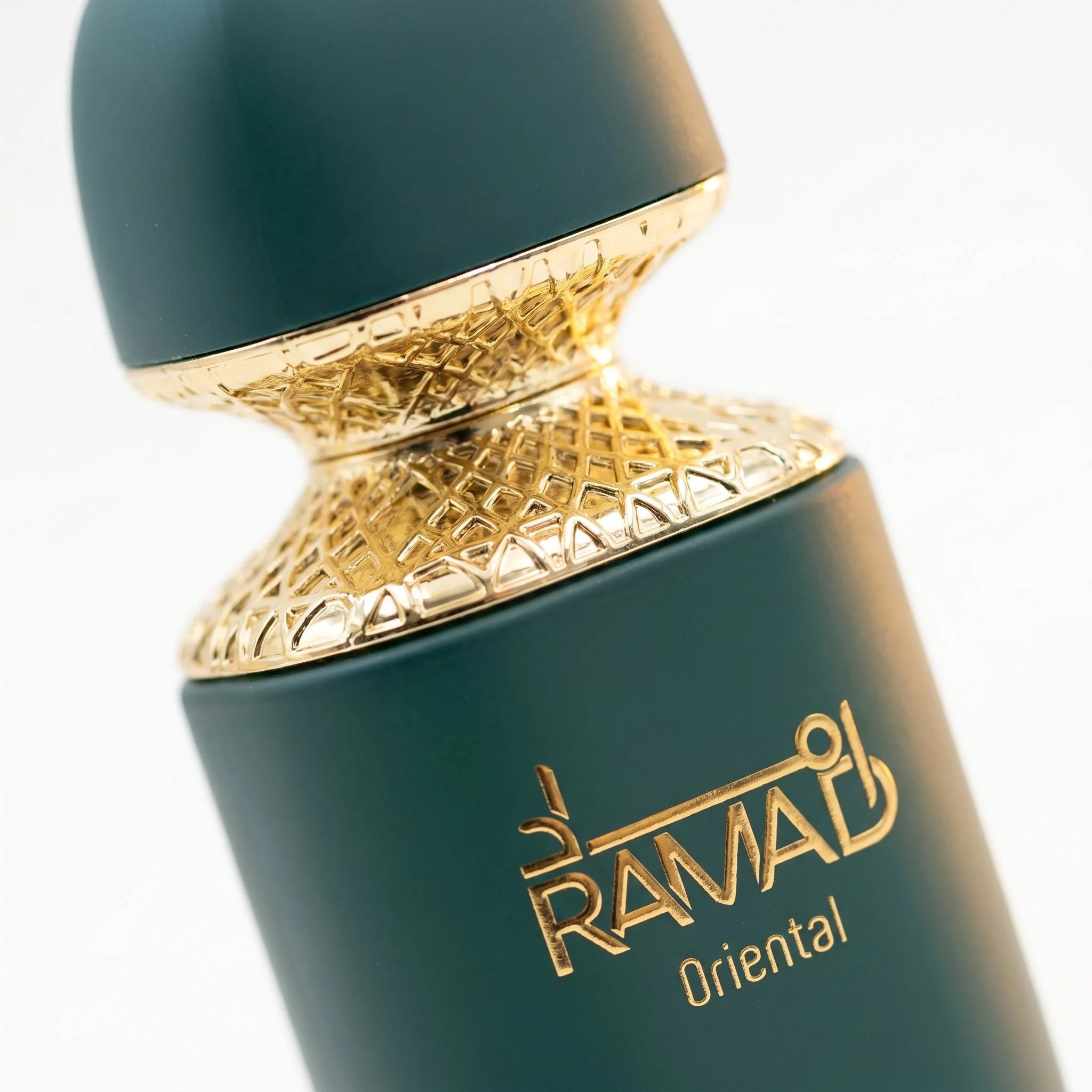Arabiyat Prestige Ramad Oriental bottle closeup showing gold lattice collar and matte teal cap detail
