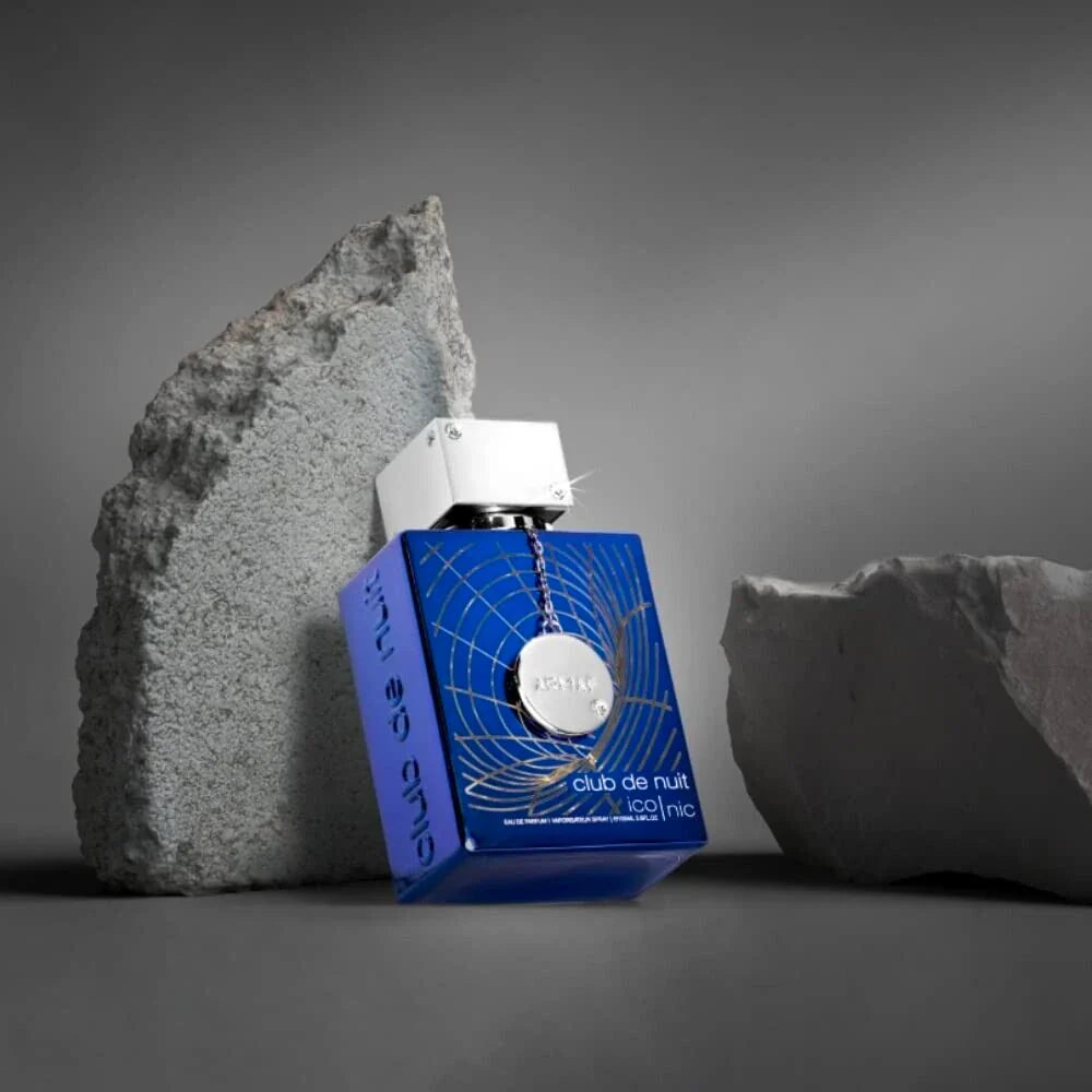 armaf club de nuit iconic blue bottle resting on a rock