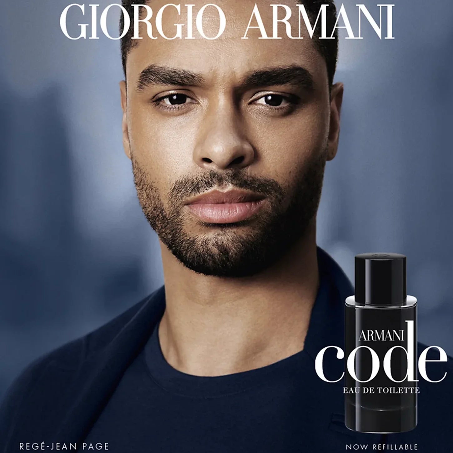 Advertisement for Giorgio Armani Armani Code cologne with a man's face and product on a blue background.