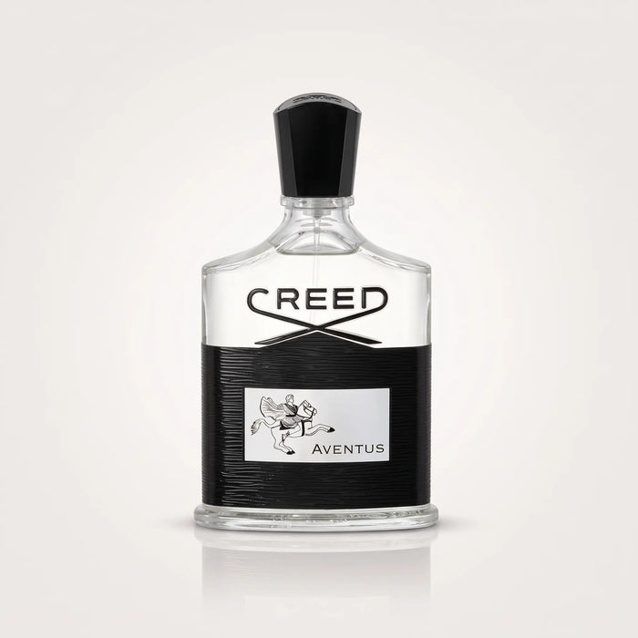 Creed Aventus Eau de Parfum bottle with a clear glass body, black cap, and a black textured label featuring the Creed logo and Aventus text.