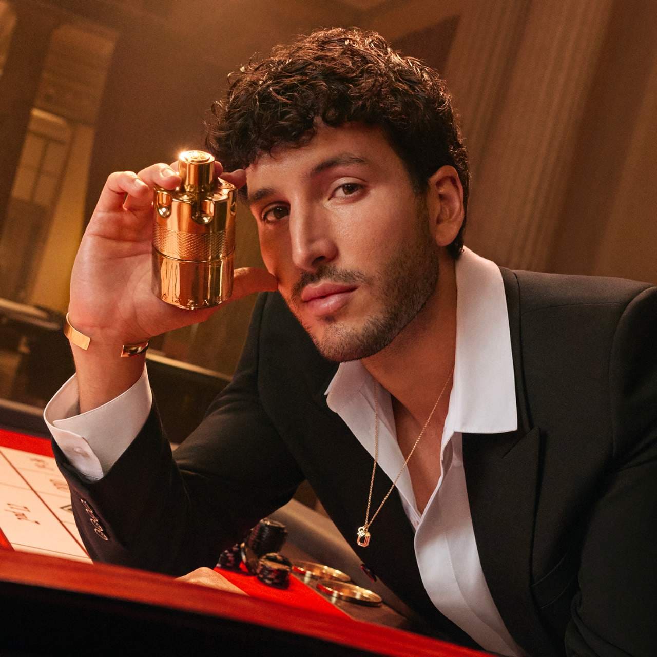 Man holding a gold object in a formal setting