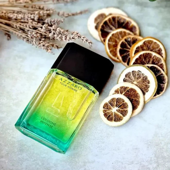 Azzaro cologne bottle with dried lemons and lavender on a light surface