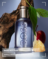 BOSS Bottled Infinite perfume bottle with apple and sandalwood on a wooden background