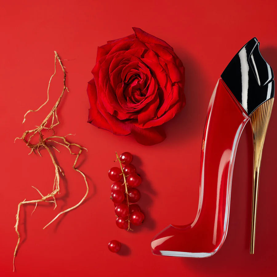 Red rose, red berries, and a high-heeled shoe on a red background