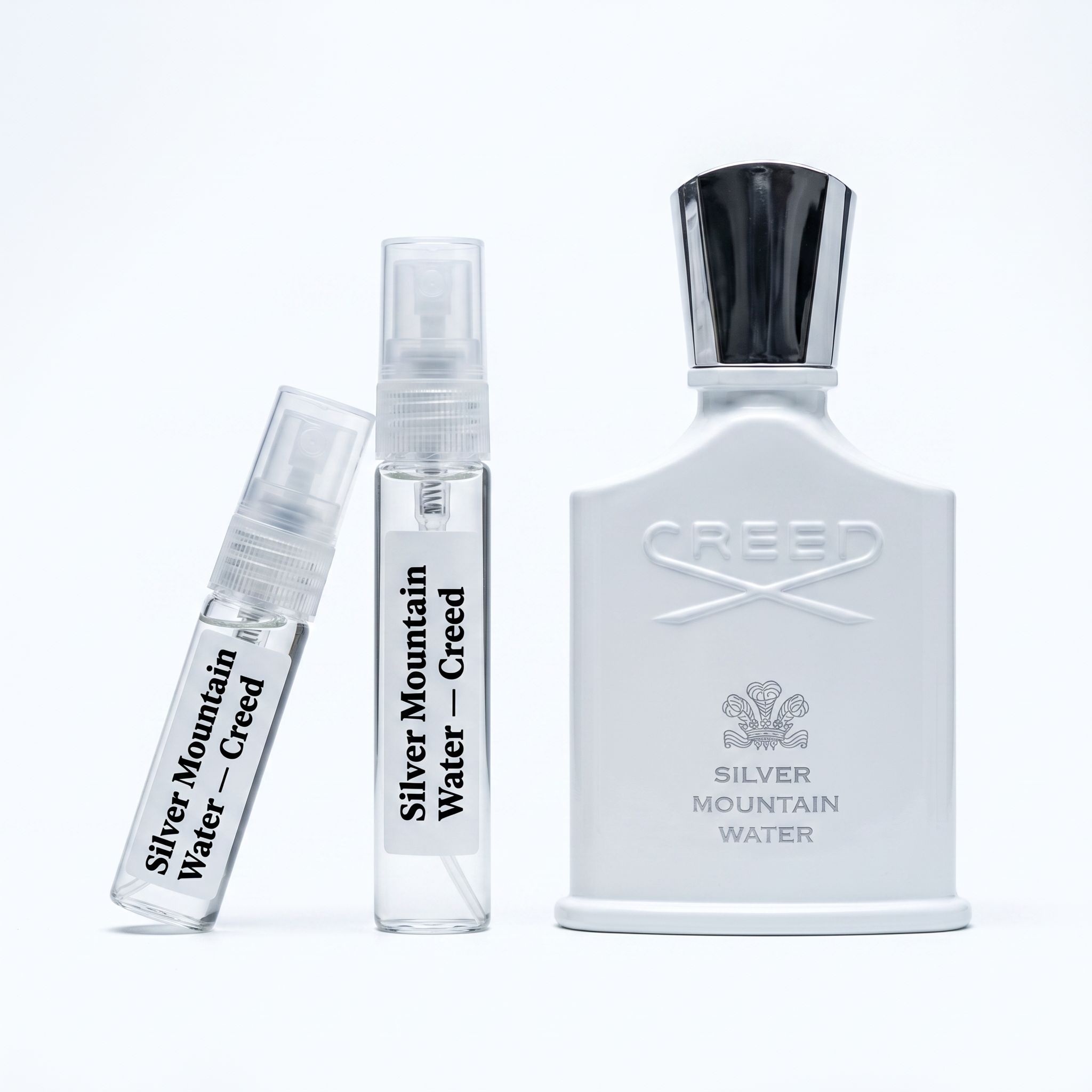 Creed Silver Mountain Water decant vials with matte white bottle on white background luxury niche fragrance photography