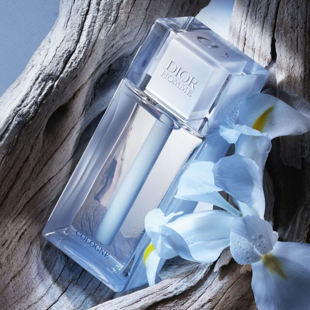 Dior perfume bottle with blue flowers on a wooden surface