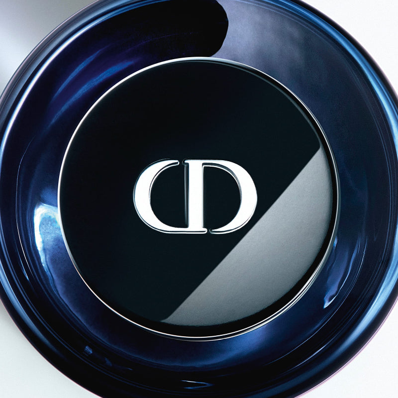 Close-up of a Dior makeup compact on a reflective surface