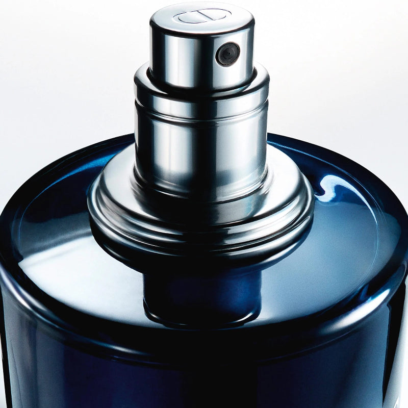 Blue perfume bottle with silver nozzle on a white background