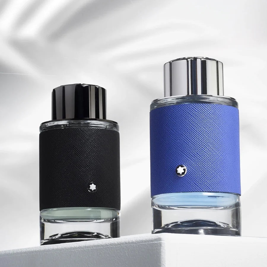 Two perfume bottles, one black and one blue with silver caps, on a reflective surface.