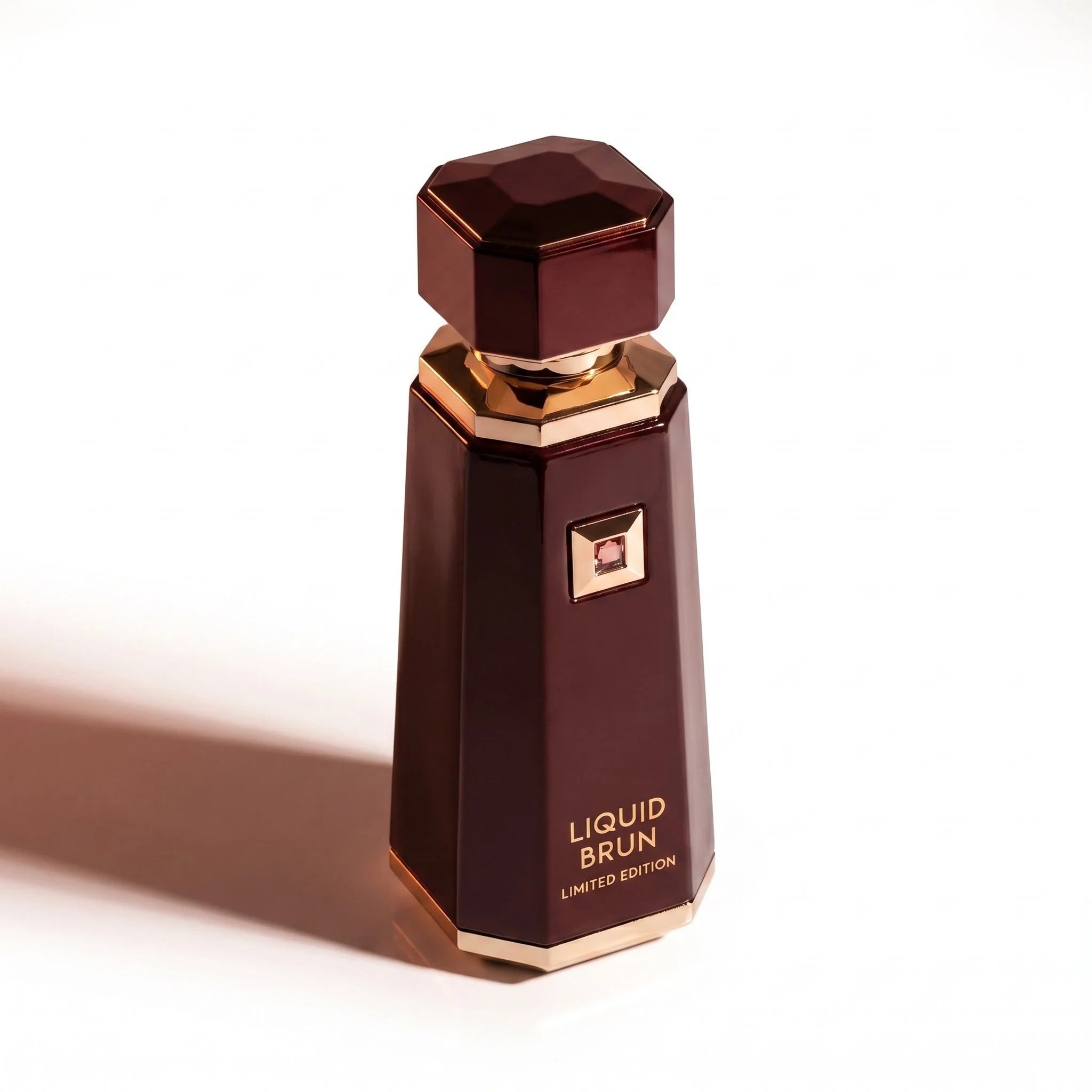 French Avenue Liquid Brun Limited Edition angled three quarter view hexagonal burgundy bottle gold gemstone luxury fragrance photography