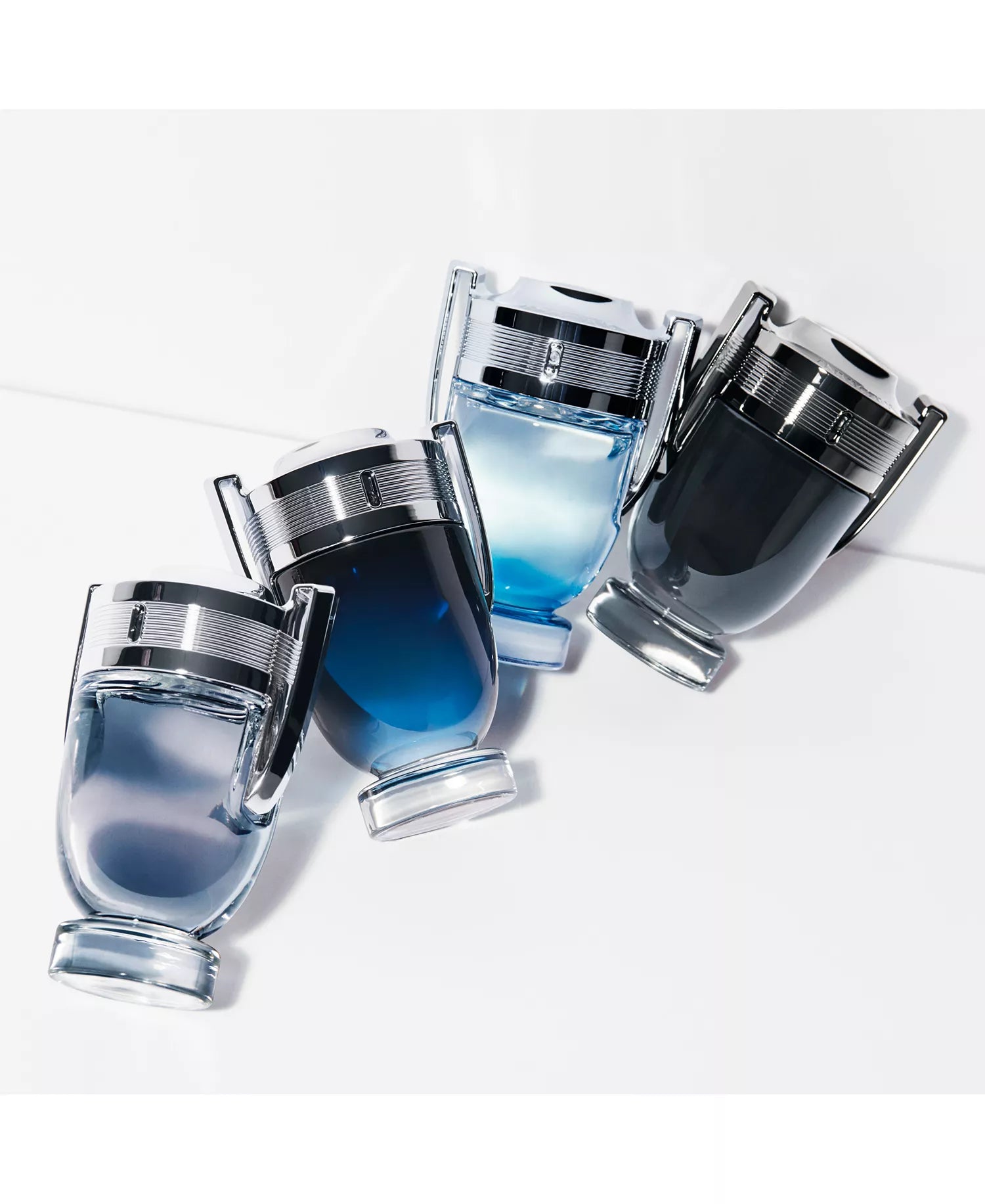Set of blue perfume bottles with silver caps on a white background