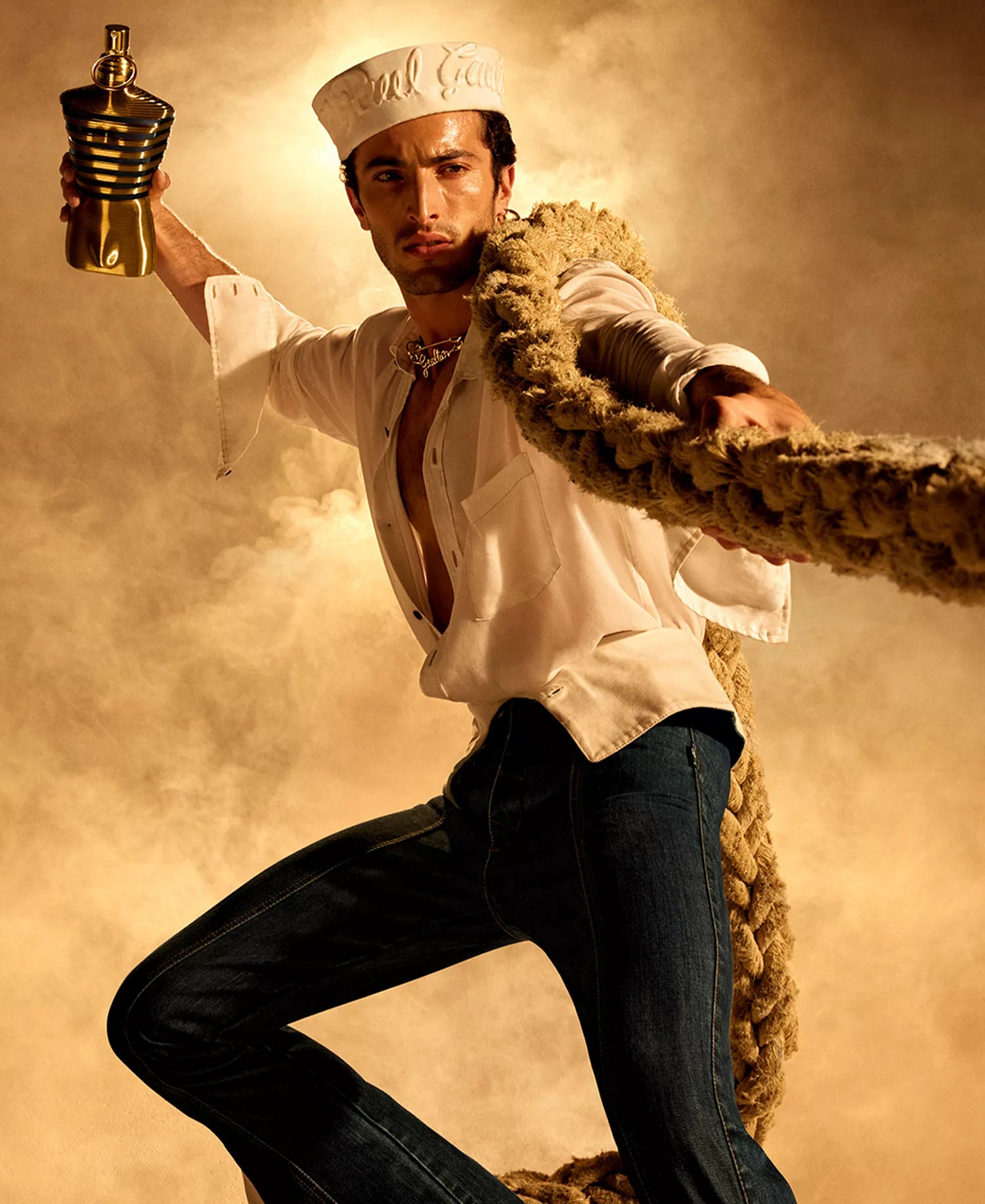 Jean Paul Gaultier Le Male Elixir men's cologne campaign featuring sailor-inspired styling with rope and nautical theme