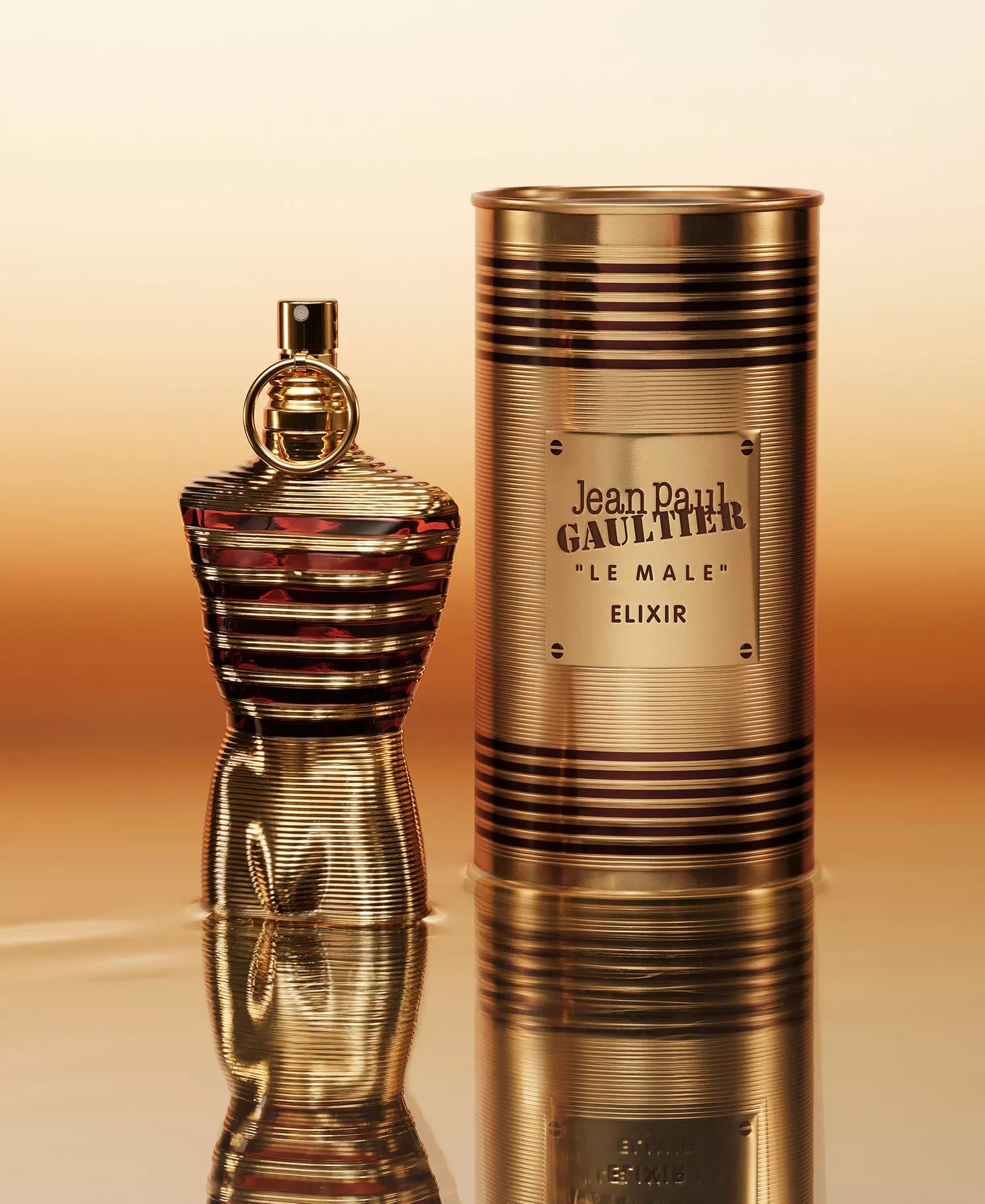 Jean Paul Gaultier Le Male Elixir Parfum in gold ribbed torso bottle with matching cylindrical tin packaging