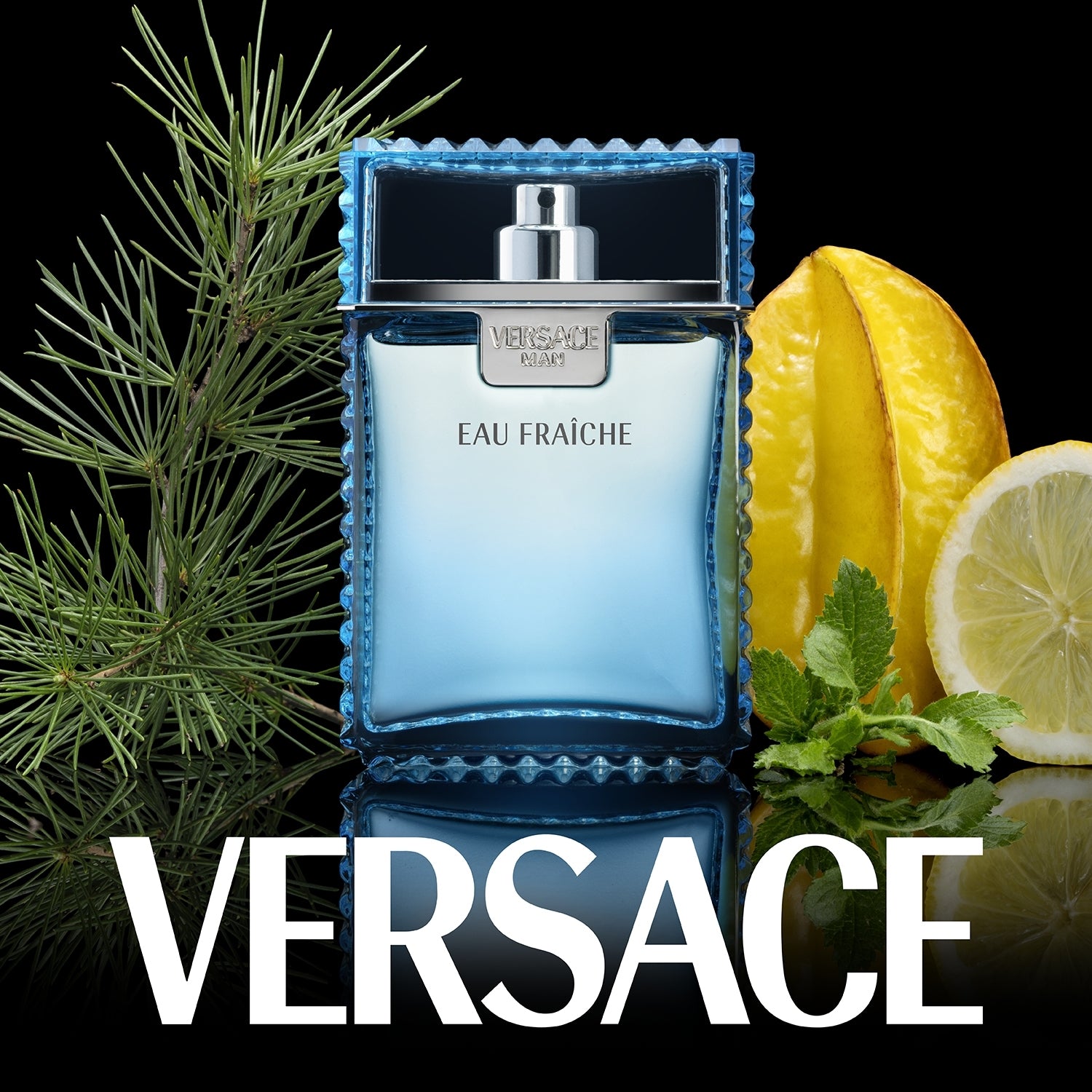 Versace Eau Fraçèche perfume bottle with lemons and mint leaves on a black background
