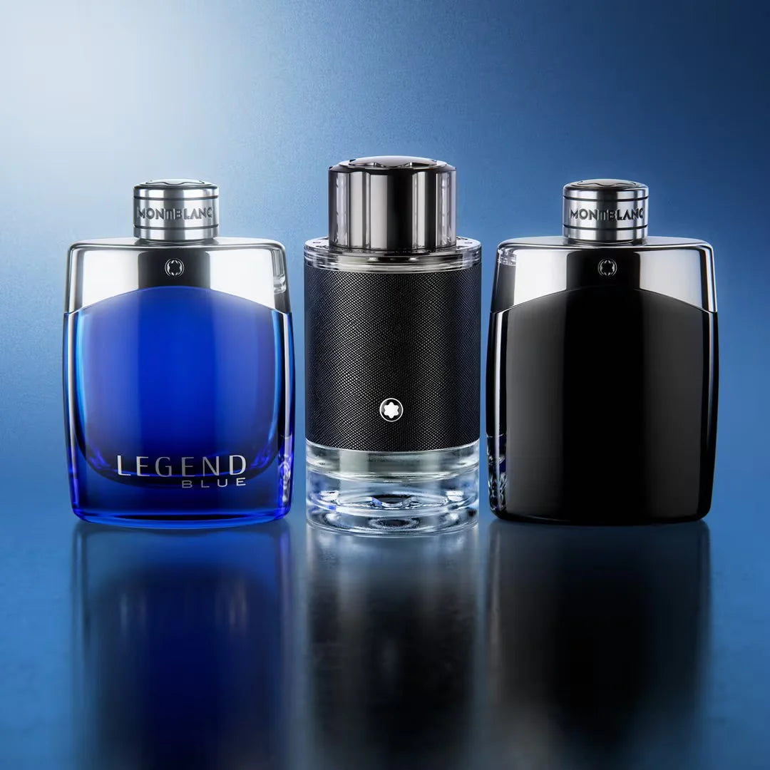 Three Montblanc perfume bottles on a reflective surface with a blue gradient background