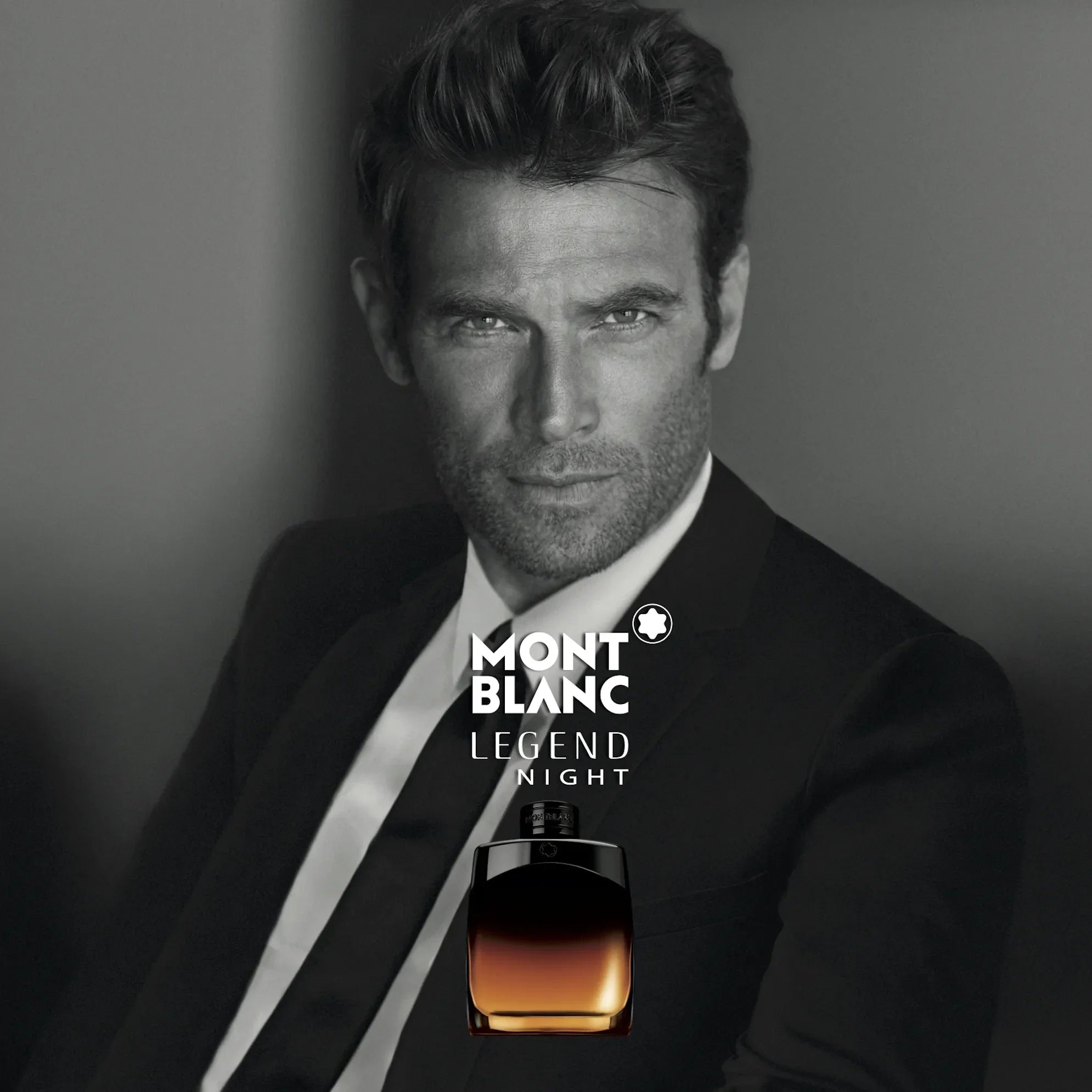 Man in a suit with Mont Blanc Legend Night perfume bottle
