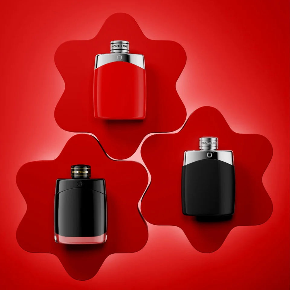 Three perfume bottles in red, black, and silver on a red background