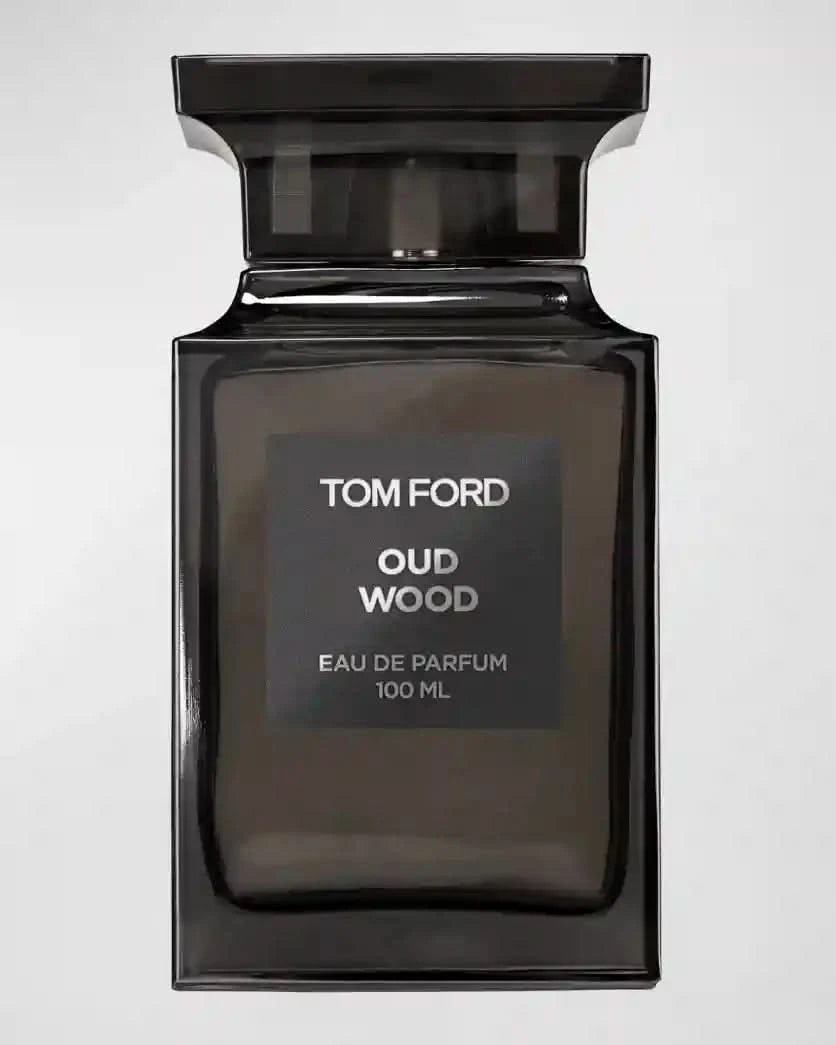 Close-up of Tom Ford Oud Wood EDP 100 ml unisex perfume bottle, showcasing elegant black design and premium label.