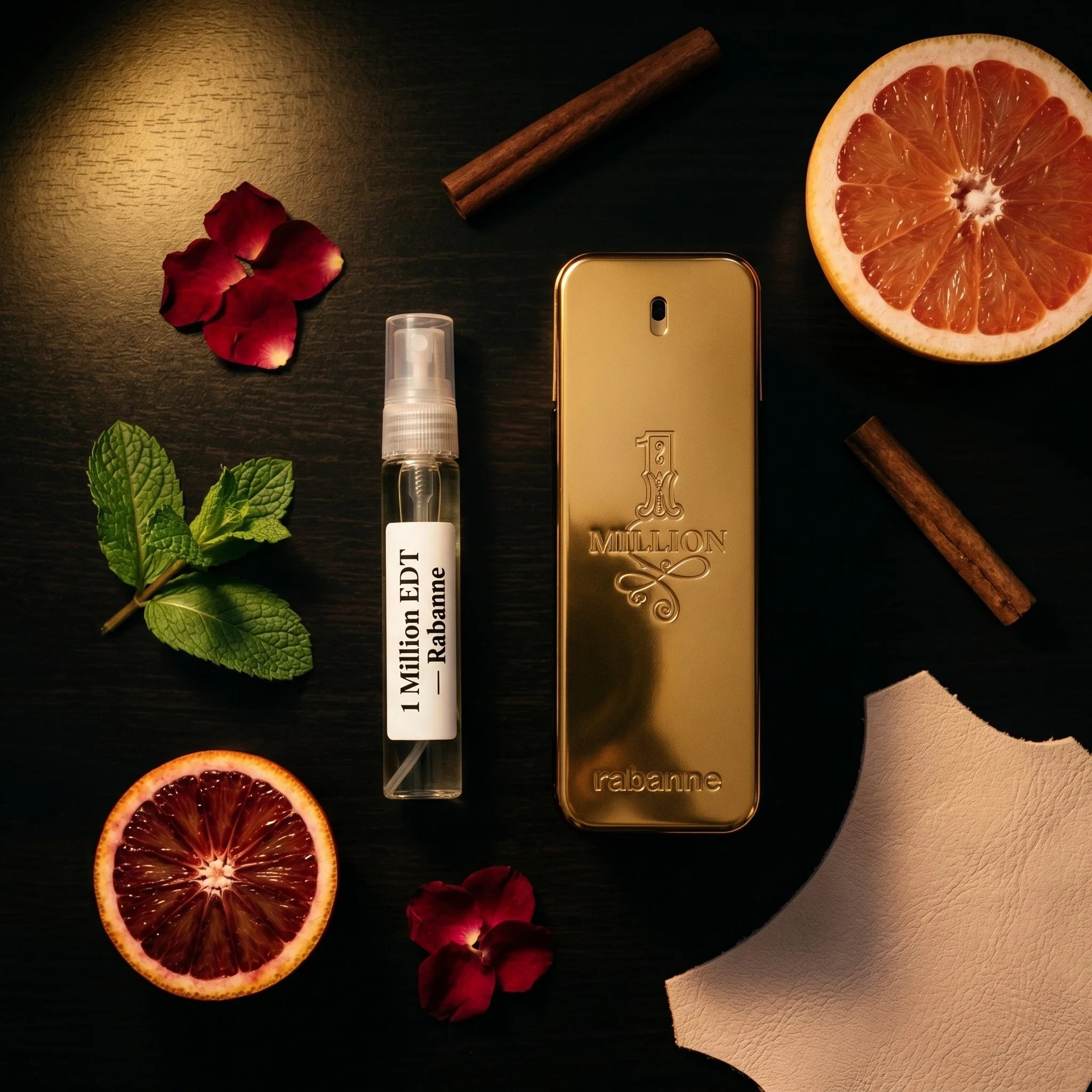 Rabanne 1 Million EDT bottle and decant on dark surface with grapefruit mint rose cinnamon leather fragrance notes flatlay