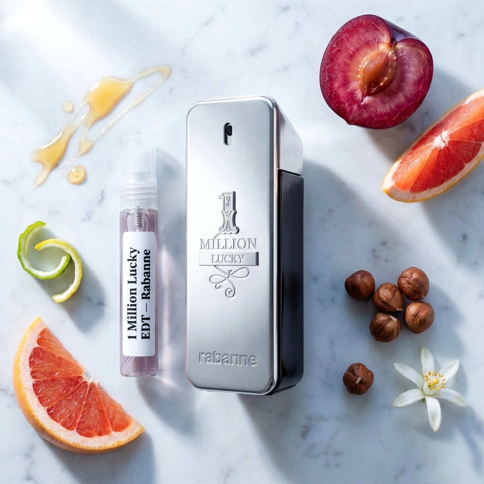 Rabanne 1 Million Lucky bottle and decant on white marble with plum grapefruit hazelnut honey orange blossom fragrance notes flatlay
