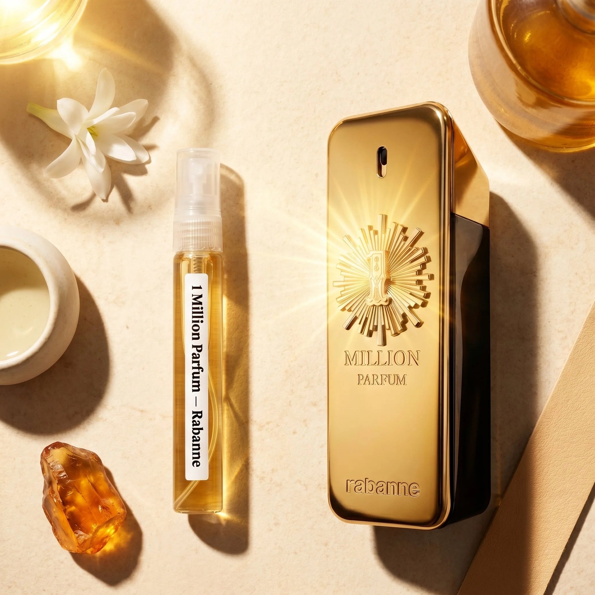 Rabanne 1 Million Parfum bottle and decant on warm sandstone with tuberose monoi oil solar leather amber fragrance notes flatlay